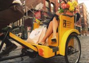 Photo: Posh woman with flowers in a pedicab.